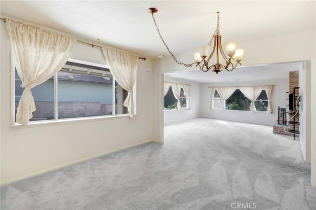 unfurnished living room with a notable chandelier and carpet flooring