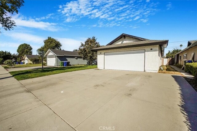 view of front of property with a front yard and a garage