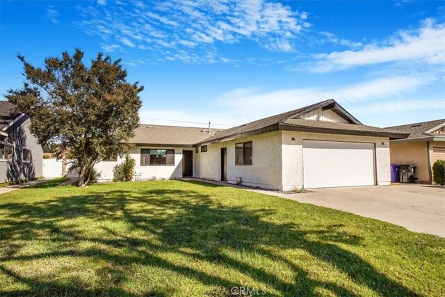 ranch-style home featuring a garage and a front lawn