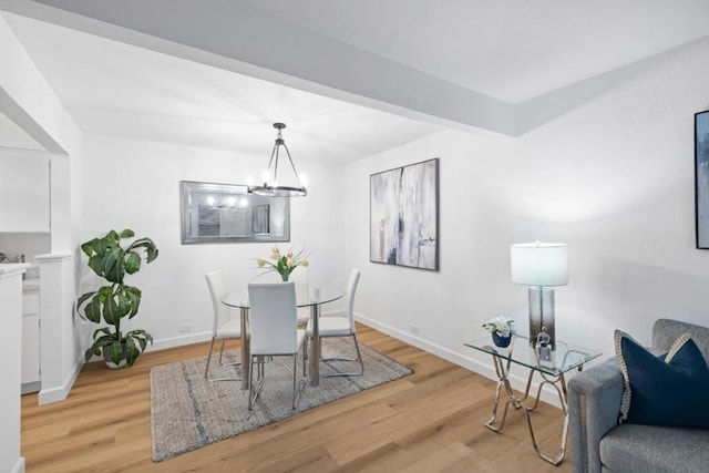 dining room with an inviting chandelier and light hardwood / wood-style floors