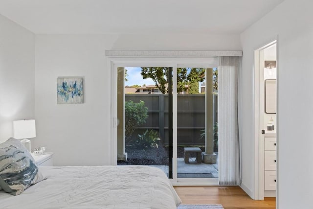 bedroom featuring hardwood / wood-style flooring and access to outside