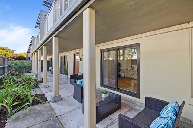 view of patio featuring outdoor lounge area and a balcony