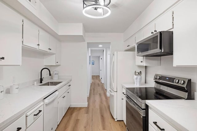 kitchen featuring light hardwood / wood-style floors, sink, stainless steel appliances, and white cabinetry