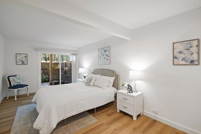 bedroom with access to exterior and light hardwood / wood-style flooring