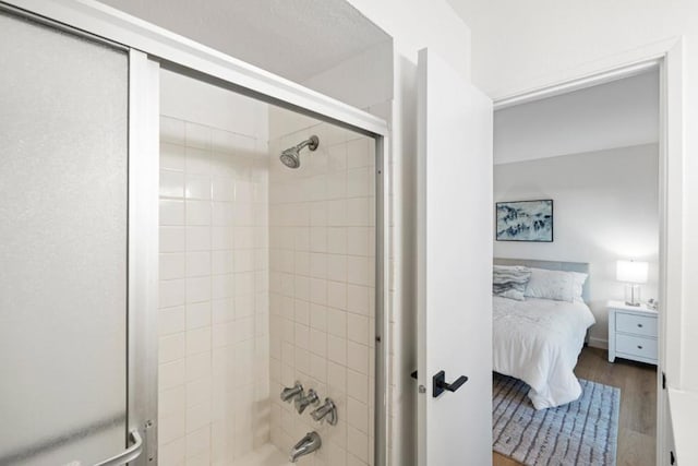 bathroom featuring combined bath / shower with glass door and hardwood / wood-style flooring