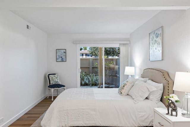 bedroom featuring access to exterior and dark hardwood / wood-style flooring