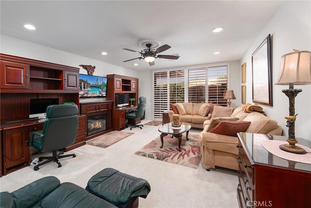 office space featuring ceiling fan and light carpet