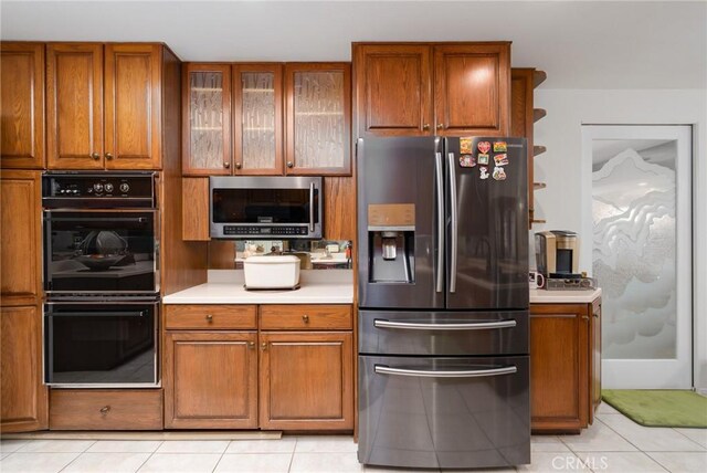 kitchen featuring light tile patterned floors and appliances with stainless steel finishes