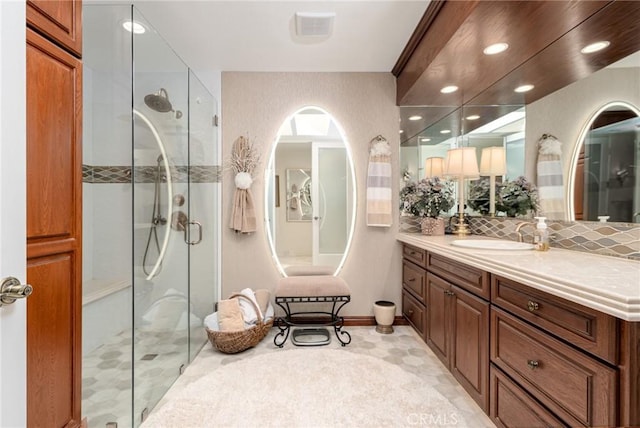 bathroom with walk in shower and vanity