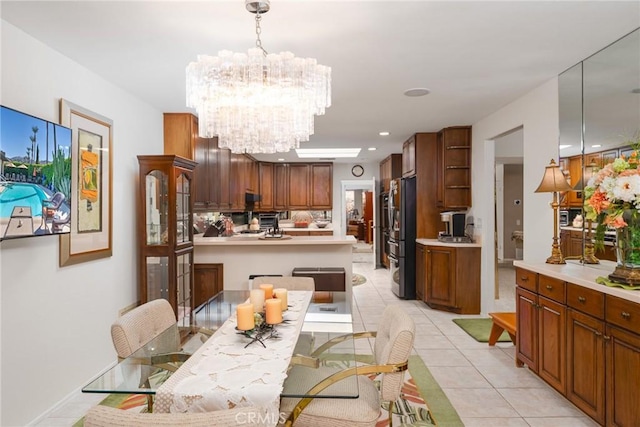 dining space featuring an inviting chandelier and light tile patterned floors