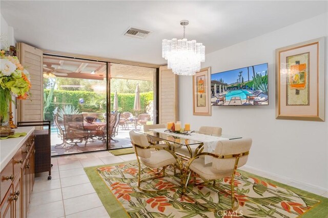 tiled dining area with a wall of windows and a notable chandelier