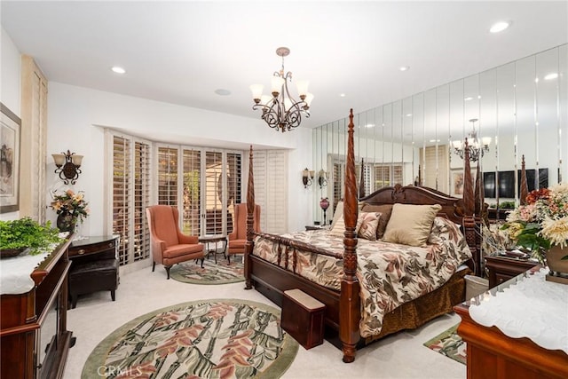 bedroom with an inviting chandelier and light colored carpet