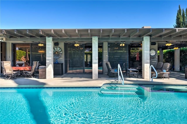 view of swimming pool featuring ceiling fan, a pergola, and a patio