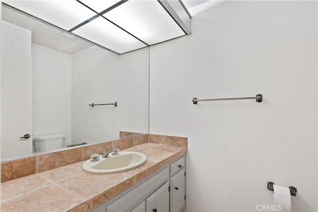 bathroom featuring toilet and vanity