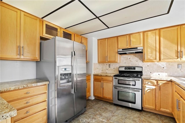 kitchen with appliances with stainless steel finishes, backsplash, and light stone countertops