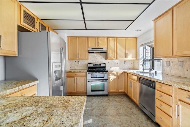 kitchen featuring light stone counters, sink, light brown cabinets, and appliances with stainless steel finishes