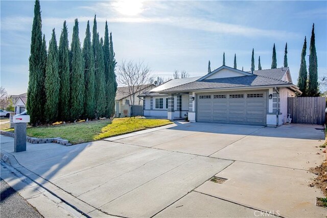 single story home featuring a front yard and a garage