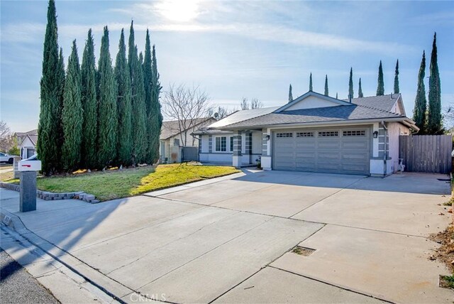 single story home with a front yard and a garage