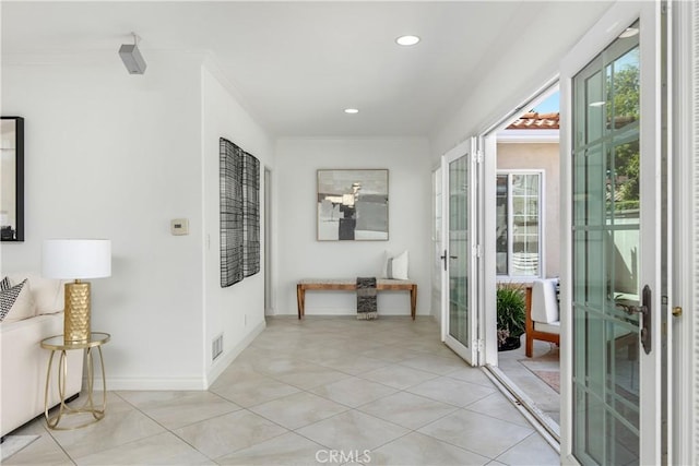 hall with ornamental molding and french doors