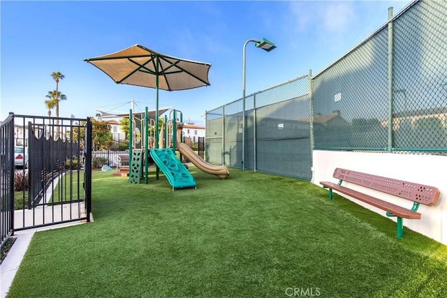 view of jungle gym featuring a lawn