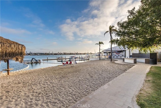 view of home's community featuring a water view and a dock