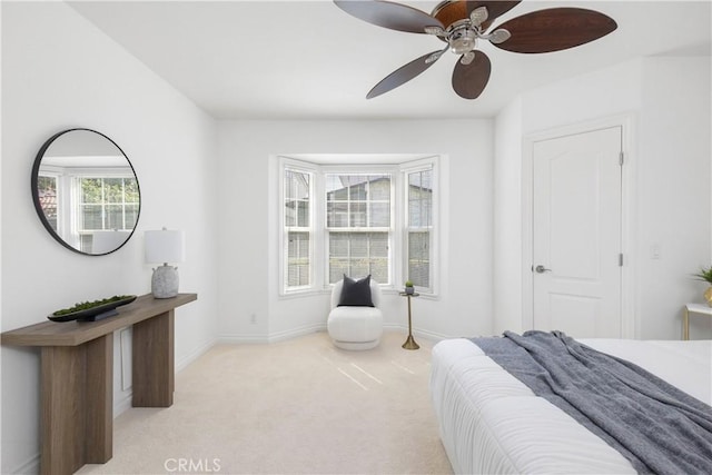 bedroom with ceiling fan and light colored carpet