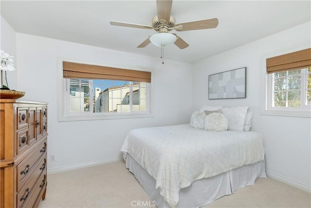 bedroom featuring ceiling fan and light colored carpet