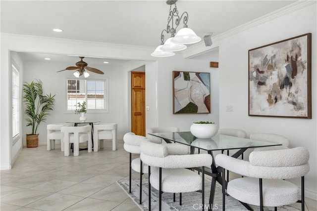 tiled dining space featuring ceiling fan and ornamental molding