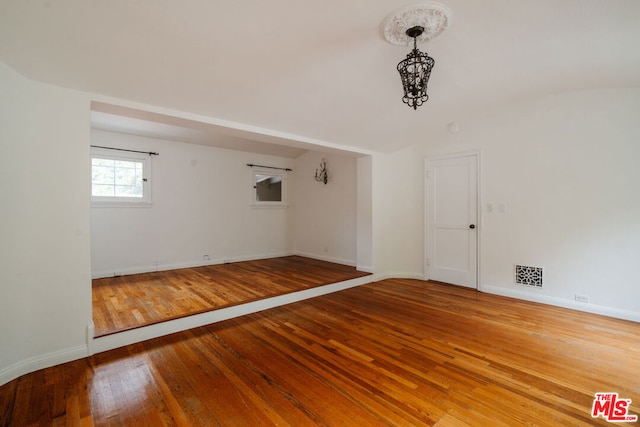 unfurnished room with hardwood / wood-style flooring