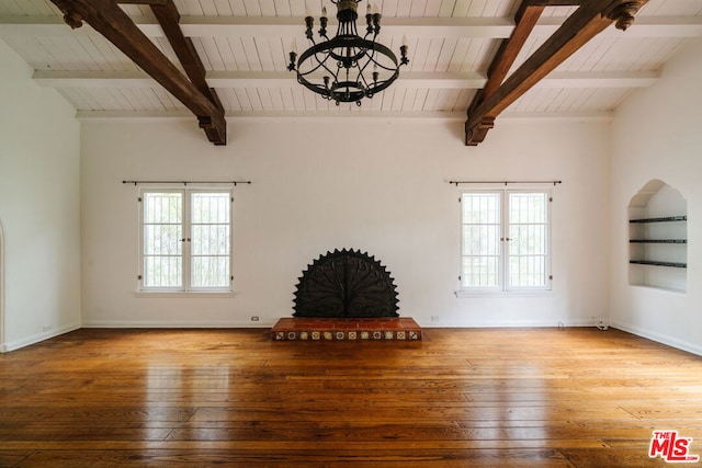 unfurnished living room with hardwood / wood-style floors, a wealth of natural light, and french doors