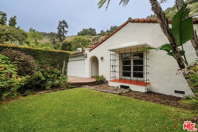 exterior space featuring a front yard and a garage