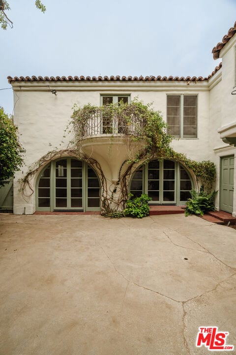 exterior space with a balcony and a patio