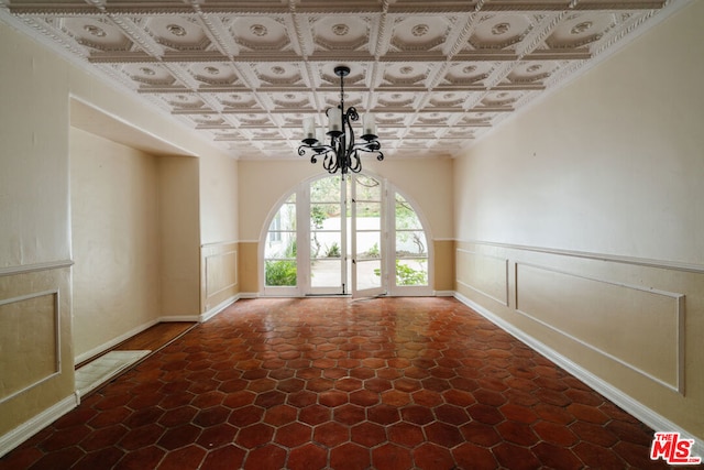 unfurnished dining area with an inviting chandelier and coffered ceiling