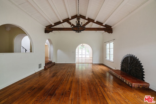 unfurnished living room featuring hardwood / wood-style flooring, ceiling fan, a fireplace, high vaulted ceiling, and beamed ceiling