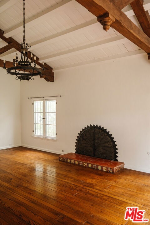 interior space featuring hardwood / wood-style floors and beamed ceiling