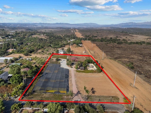 birds eye view of property with a mountain view