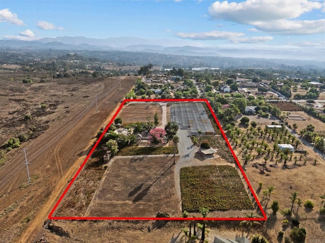 birds eye view of property featuring a mountain view