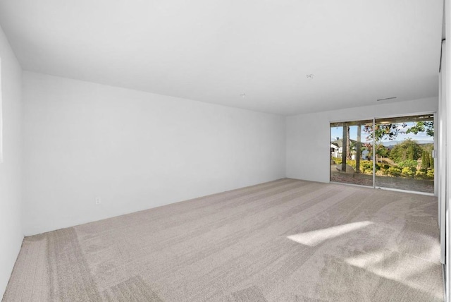 unfurnished room with light colored carpet