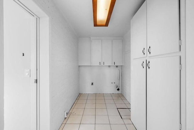 washroom featuring light tile patterned flooring, electric dryer hookup, washer hookup, and cabinets