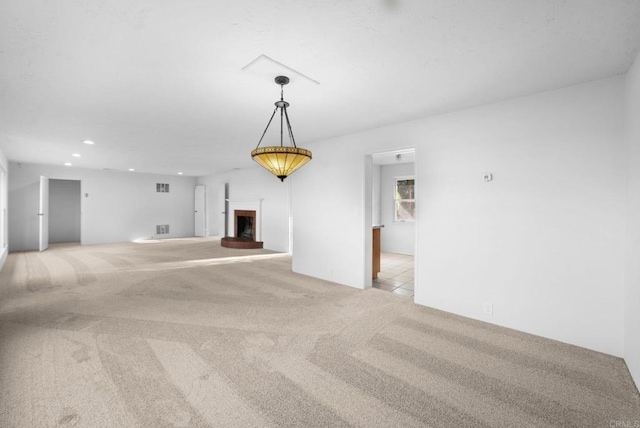 unfurnished living room with light colored carpet