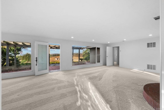 unfurnished living room featuring light carpet