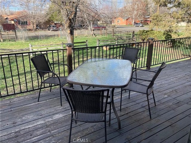 wooden terrace featuring a yard