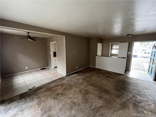 unfurnished living room featuring ceiling fan and light colored carpet