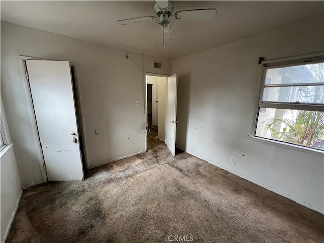 unfurnished bedroom featuring ceiling fan and carpet