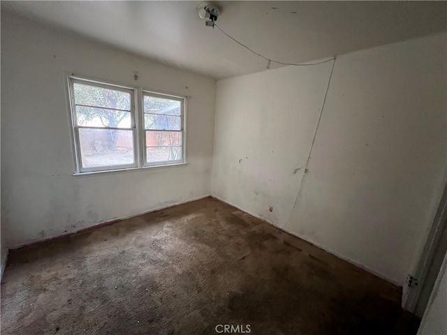 empty room featuring dark carpet