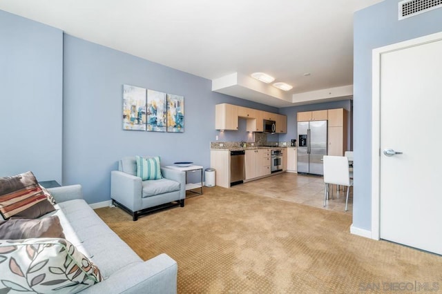 living room featuring light carpet