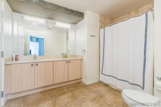 bathroom featuring toilet, a shower with curtain, and vanity