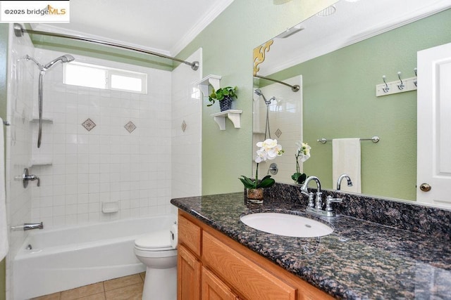 full bathroom with toilet, vanity, tile patterned flooring, washtub / shower combination, and crown molding