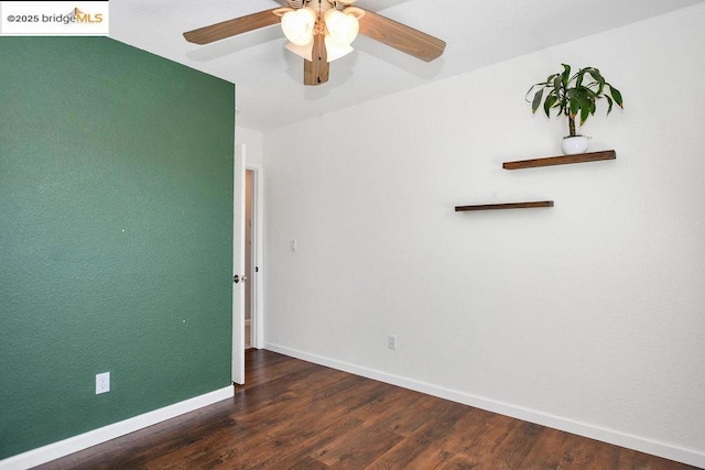 empty room with ceiling fan and dark wood-type flooring