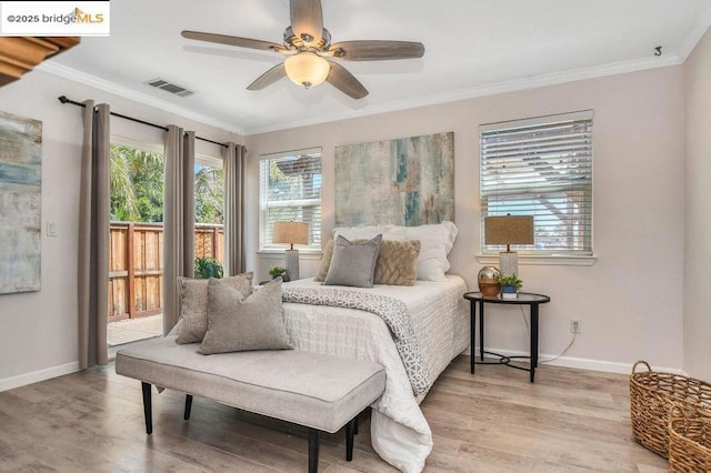 bedroom with ceiling fan, light wood-type flooring, and ornamental molding